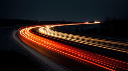 A stunning image of long exposure shot of a curving road at night, capturing the streaks of red lights from passing cars.