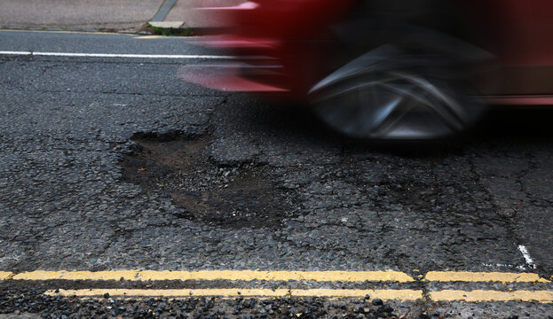 A car travelling towards a pothole