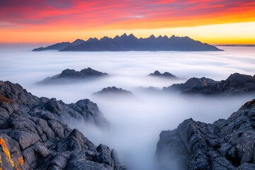Fototapeta premium Majestic Mountain Peaks Emerging from a Sea of Clouds at Sunset A Breathtaking View of Dramatic Landscapes