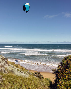 Elevated view of a beach and kitesurfer