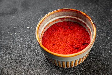Ground hot red pepper cayenne pepper paprika spice appetizer vegetables dish organic product fresh tasty gourmet food background on the table rustic food top view copy space