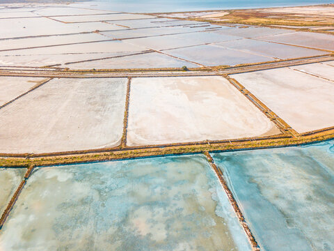 Aerial view of salt evaporation ponds of various shapes