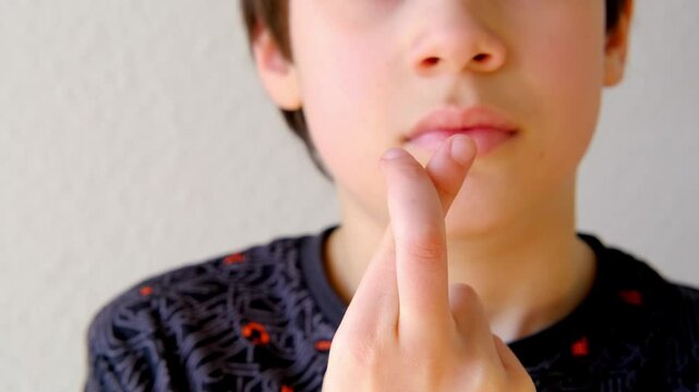 Close-up of child's crossed fingers for luck, 10-year-old boy making motivational gesture symbolizing hope, support, optimism concept emotional development, encouraging gestures, childhood optimism