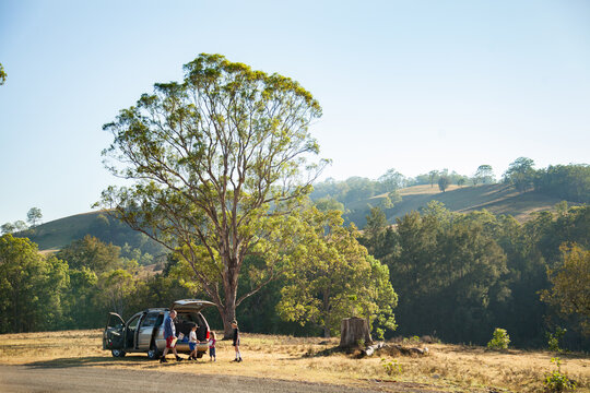 Family getting out of car stopped on the roadside for a break