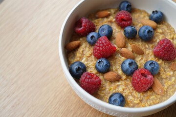 Oatmeal porridge with blueberries, raspberries and almonds
