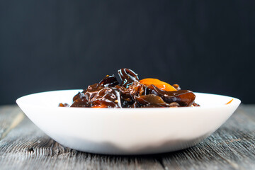 Wood ear mushrooms with vegetables on dark background. vegan food