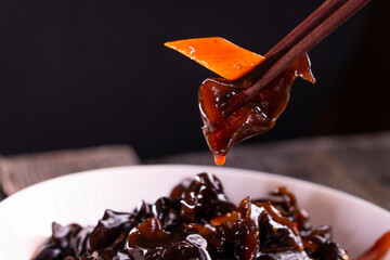 Wood ear mushrooms with vegetables on dark background. vegan food