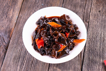Wood ear mushrooms with vegetables on dark background. vegan food
