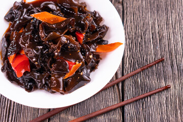 Wood ear mushrooms with vegetables on dark background. vegan food