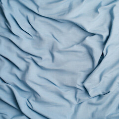 Fototapeta premium Soft light blue bed sheet fabric texture creates calming and serene atmosphere, perfect for enhancing any bedroom decor. gentle folds add depth and elegance to design