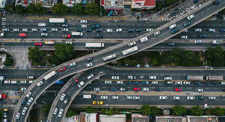 Aerial view of a busy highway with multiple lanes and overpasses filled with cars and trucks moving along