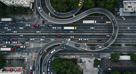 Aerial view of a busy highway with multiple lanes and overpasses filled with cars and trucks moving slowly