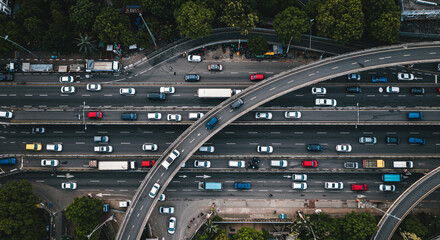 Aerial view of a multi lane highway with many cars and trucks traveling in both directions in daylight