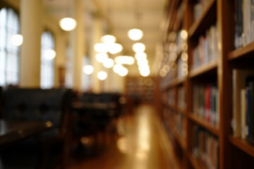 Warm and inviting library interior filled with wooden bookshelves and soft lighting during a quiet...