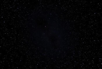 Inky black sky ablaze with countless stars, cosmic dust shimmering, space, galactic