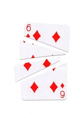 A playing card in the suit of diamonds cut into sharp pieces.