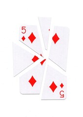 A playing card in the suit of diamonds cut into sharp pieces.