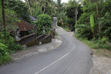 Road with a bridge and a house in the background