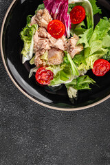 Tuna salad canned fish mixed green leaf lettuce seafood appetizer vegetable dish organic fresh tasty gourmet food background on the table rustic top view copy space vegetarian food pescetarian diet