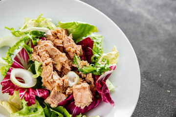 Tuna salad canned fish mixed green leaf lettuce seafood appetizer vegetable dish organic fresh tasty gourmet food background on the table rustic top view copy space vegetarian food pescetarian diet