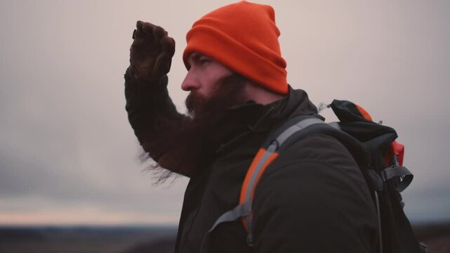 Man Standing on Cliff Overlooking Vast Icelandic Landscape