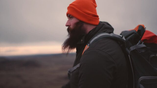 Man Standing on Cliff Overlooking Vast Icelandic Landscape