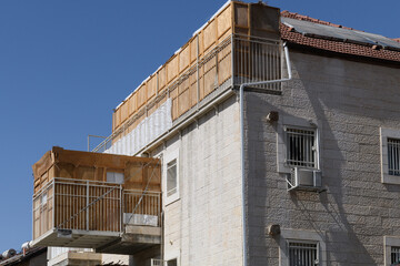 A sukkah, or succah, a temporary, wooden dwelling with a thatch roof, built on a balcony in a residential neighborhood of Jerusalem during the weeklong Jewish holiday of Sukkot in Israel.