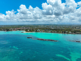 Fototapeta premium Aerial panorama of Grand Baie coastline with homes, beach, and turquoise waters