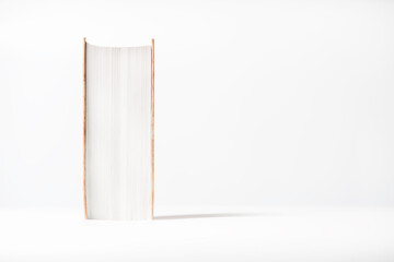 Thick book on white background. Battered volume creating an atmosphere of comfort and nostalgia. The concept of knowledge and secluded reading.