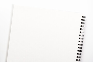 Empty blank notebook with spiral lies on white background.