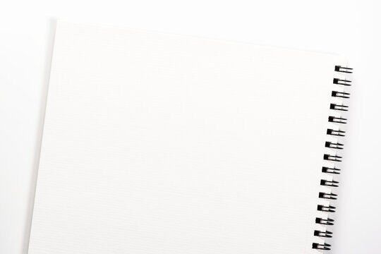 Empty blank notebook with spiral lies on white background.