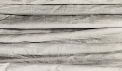Row stacked crumpled sheet in grey.