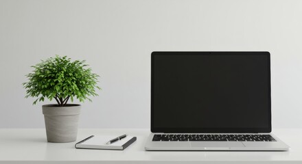 Fototapeta premium Minimalist Workspace: Laptop, Notepad, and Potted Plant on White Desk