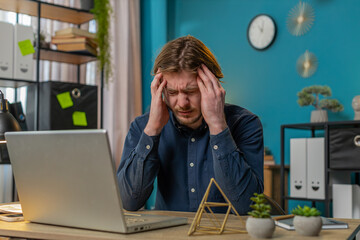 Tired ill Caucasian businessman suffering from headache problem tension and migraine, stress at...