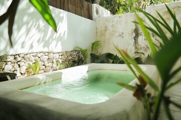 Relaxing green tile plunge pool surrounded by tropical plants in a private outdoor space during a sunny afternoon in a serene location