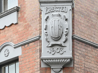 Erected in 1903 sign at logo close-up of the signage to the building in Brick Lane, London, United Kingdom, 21 December 2024