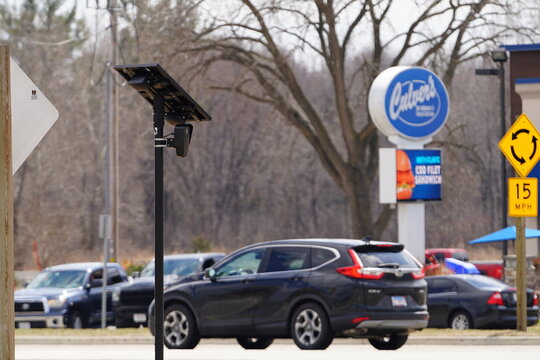 Flock safety police law enforcement license plate reader set up outside to help catch vehicle speeders.