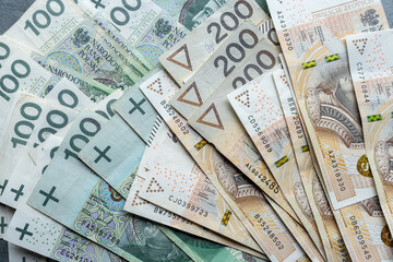 Top view 100 200 polish zloty banknotes with stack of money
