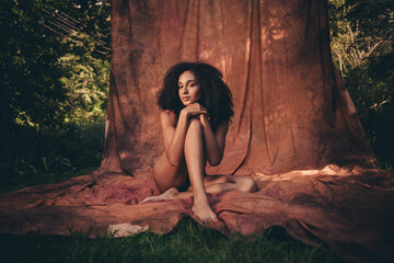 Modern art photosession outdoors of fashion model gentle lady wearing nothing posing isolated on brown textile background