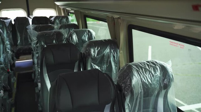 Charming minibus interior showcases well-designed passenger seats wrapped for protection. Seating is arranged for comfort and convenience, perfect for group travel. Ideal for adventures.