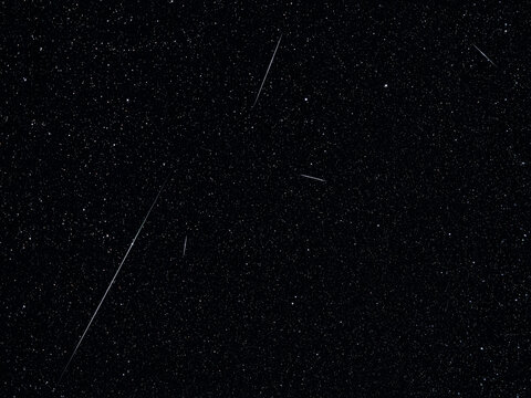 Lyrid meteor shower streaks across a star-filled night sky.