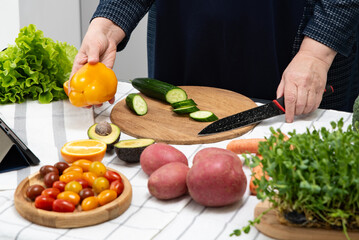fat woman cooking online recipe with tablet close up. Meal time