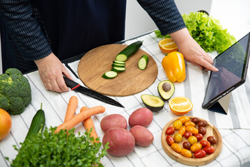 woman cooking online recipe with tablet. Meal Time