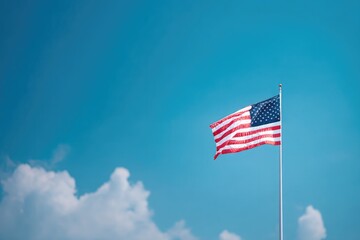 Fototapeta premium minimalistic image of single american flag fluttering in breeze against vibrant blue sky