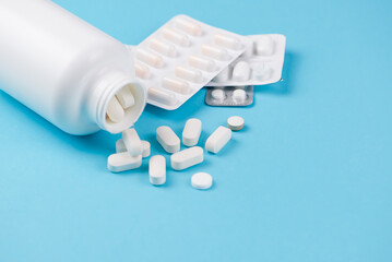 A collection of pharmaceutical pills and capsules stored in a bottle for various uses