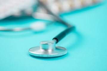 A CloseUp of a Stethoscope against a Blue Background, highlighting its use in medical exams