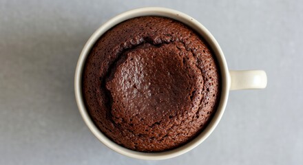 Fototapeta premium Overhead shot of chocolate lava cake in a mug, a warm dessert concept for valentine day and sweet treat ideas, indulgent homemade baked goods, easy recipe