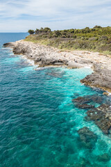 View of the rugged coastline with pristine turquoise waters and Mediterranean vegetation near Cape Kamenjak, Croatia