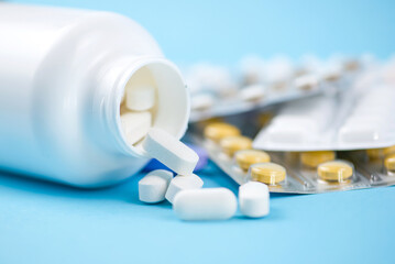 A collection of pharmaceutical pills and capsules stored in a bottle for various uses