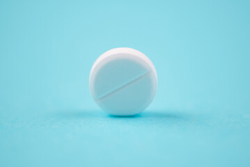 Pills and other medications close-up on blue background, health and medicine